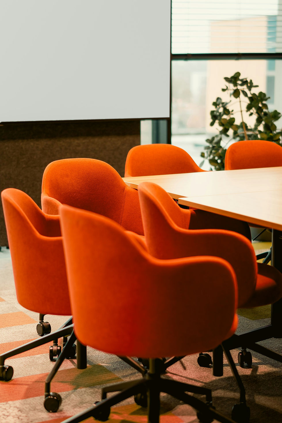 Orange conference chairs around table