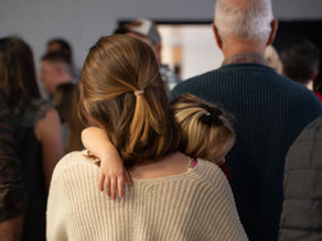 Woman heading into church while holding her child.