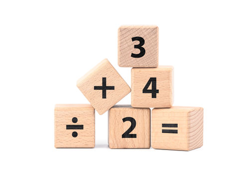 wooden blocks displaying numbers and mathematical operations