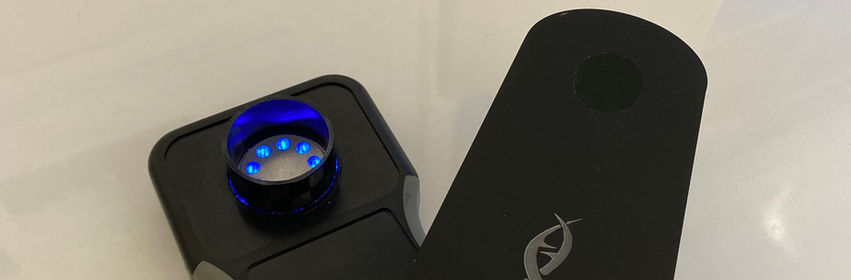 TEh second generation DNAiTECH portable isothermal amplification instrument in the lab alongside the Ahram RX1 portable centrifuge.