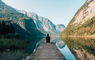 Canva - Person on a Bridge Near a Lake c