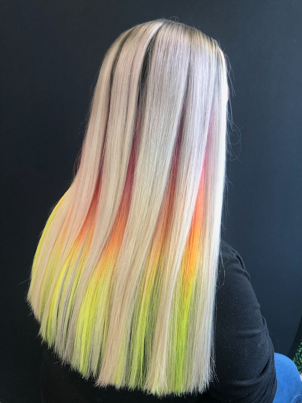 Back view of white blonde hair with red, orange, yellow, and green color melt underneath.