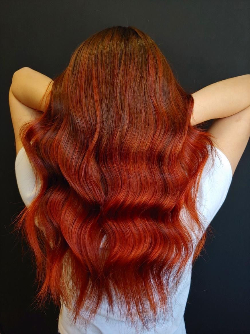 Brown to burgundy balayage wavy hair.