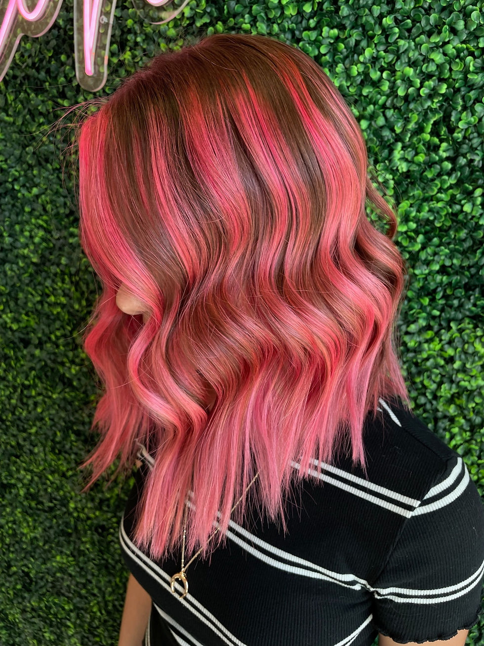 Brown to pink balayage with pink money pieces framing the face.