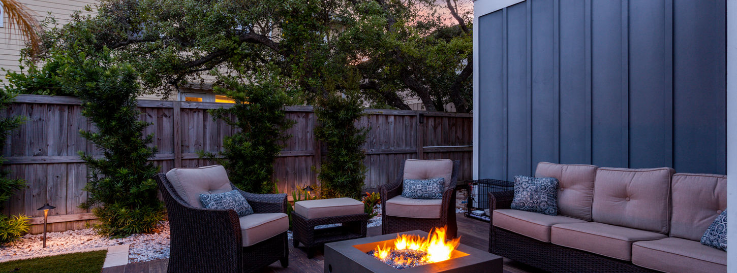 Beautiful backyard firepit at dusk with comfortable chairs.jpg