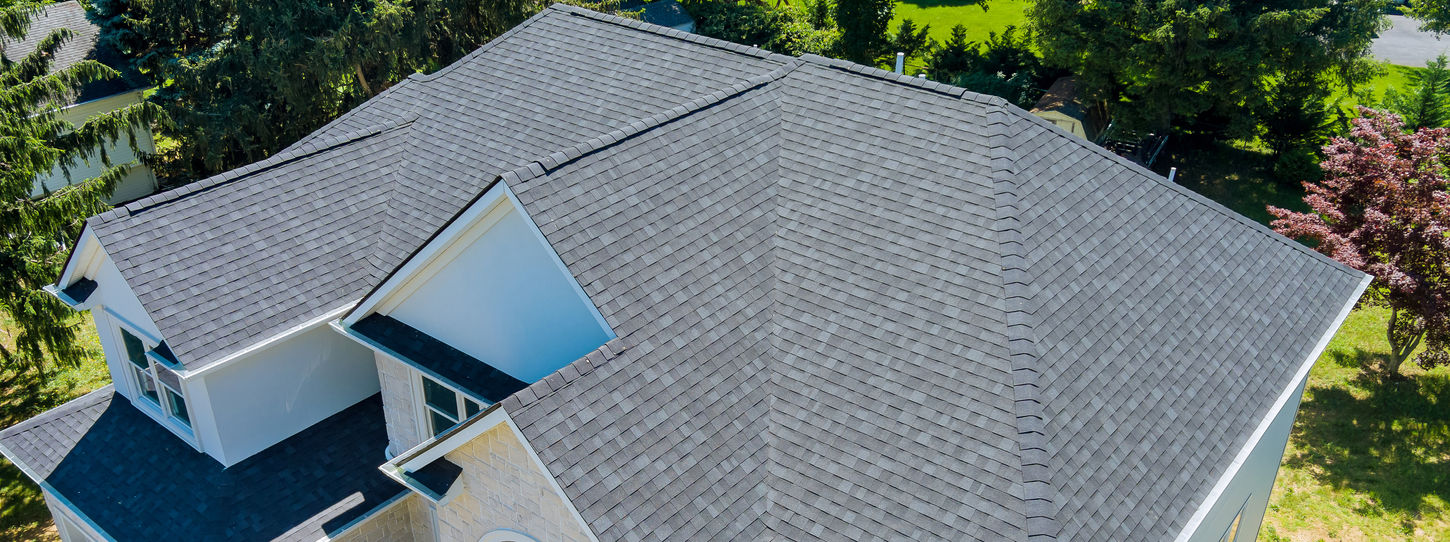 Aerial view of asphalt shingles construction site roofing the house with new window.jpg