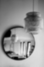 Interior detail photography France — rattan lamp circular mirror