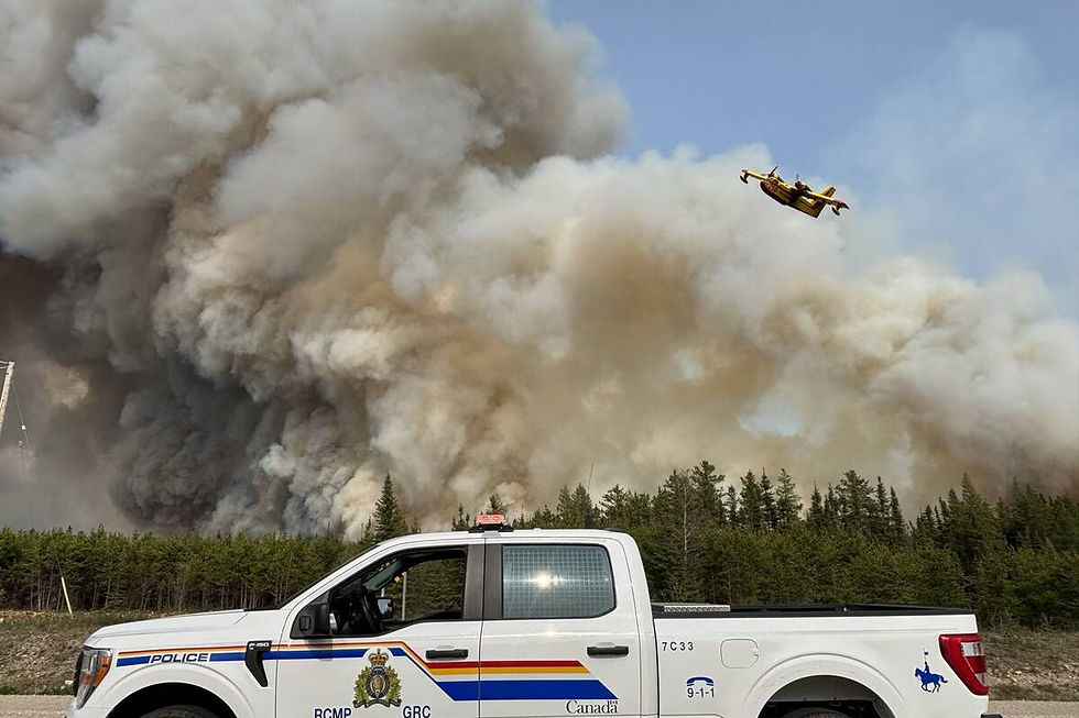 Fires rage in northwestern Manitoba May 30, sending thick smoke into the air and prompting mass evacuations and widespread air quality warnings. Photo: Pool/Latin America News Agency/Reuters Connect