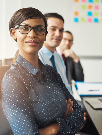 confident-woman-seated-with-men-in-meeting-2024-09-16-23-25-10-utc.jpg