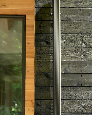 Detail of clear finish cedar and charred cedar siding