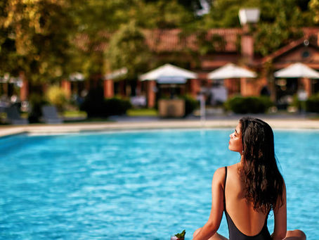 Outdoor swimming pool and gardens at San Clemente Palace Venice.