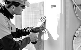 workman-installing-outdoor-unit-of-the-a