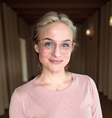 Professional headshot of a smiling female clinical supervisor and spiritual guide in a soft pink top, offering therapy, consulting, and supervision services.