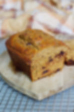 protein pumpkin loaf cut into on a wooden cutting board
