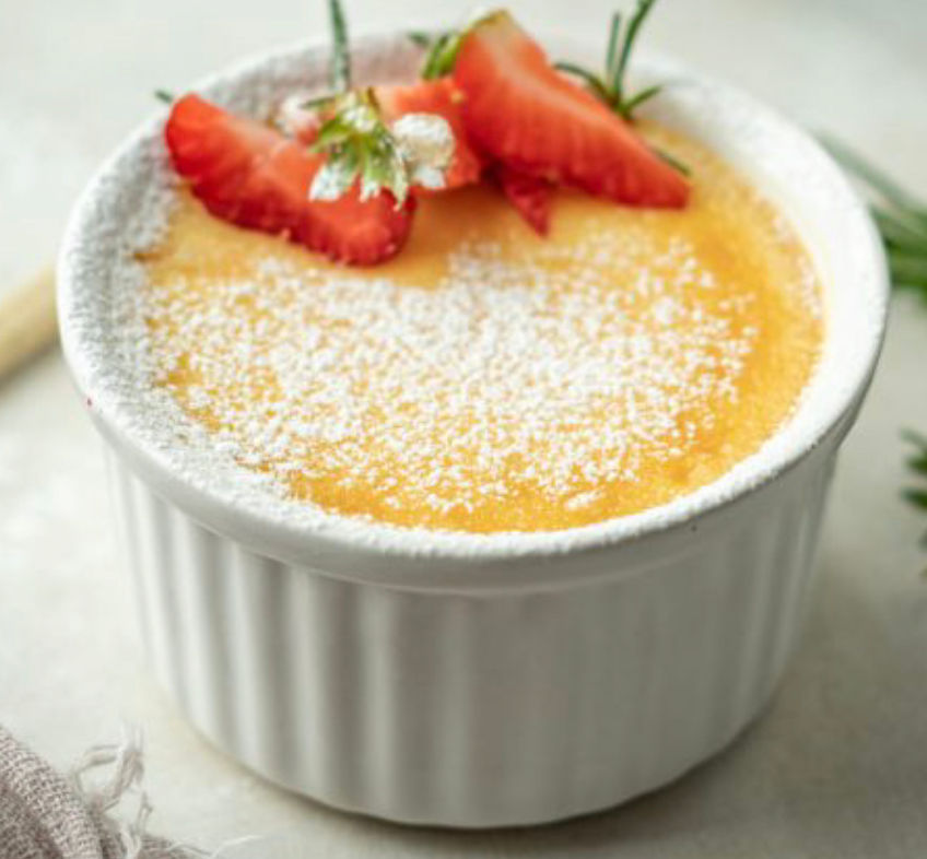 ramekin with custard and topped with strawberries