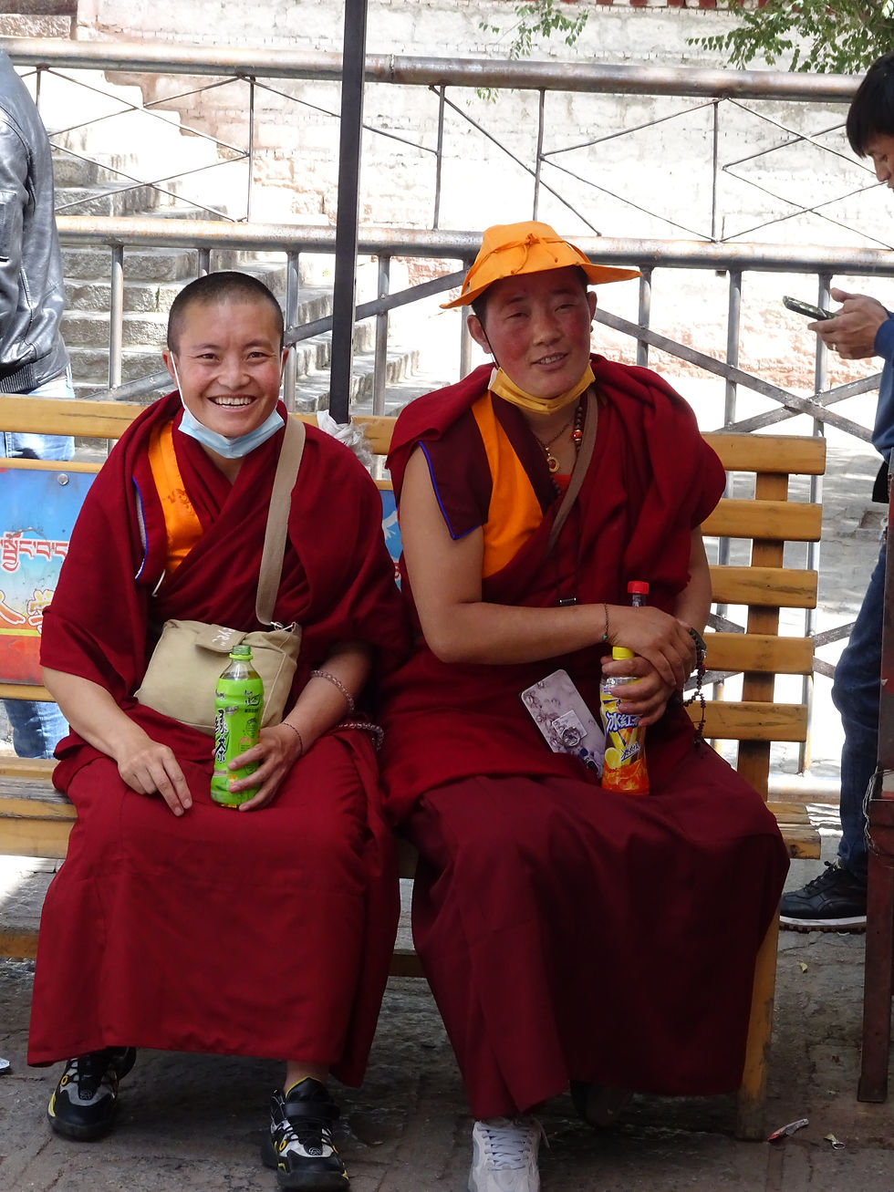monks, red, red robes, travel, travelling, tired, soft drinks, sports shoes, smile, friendly