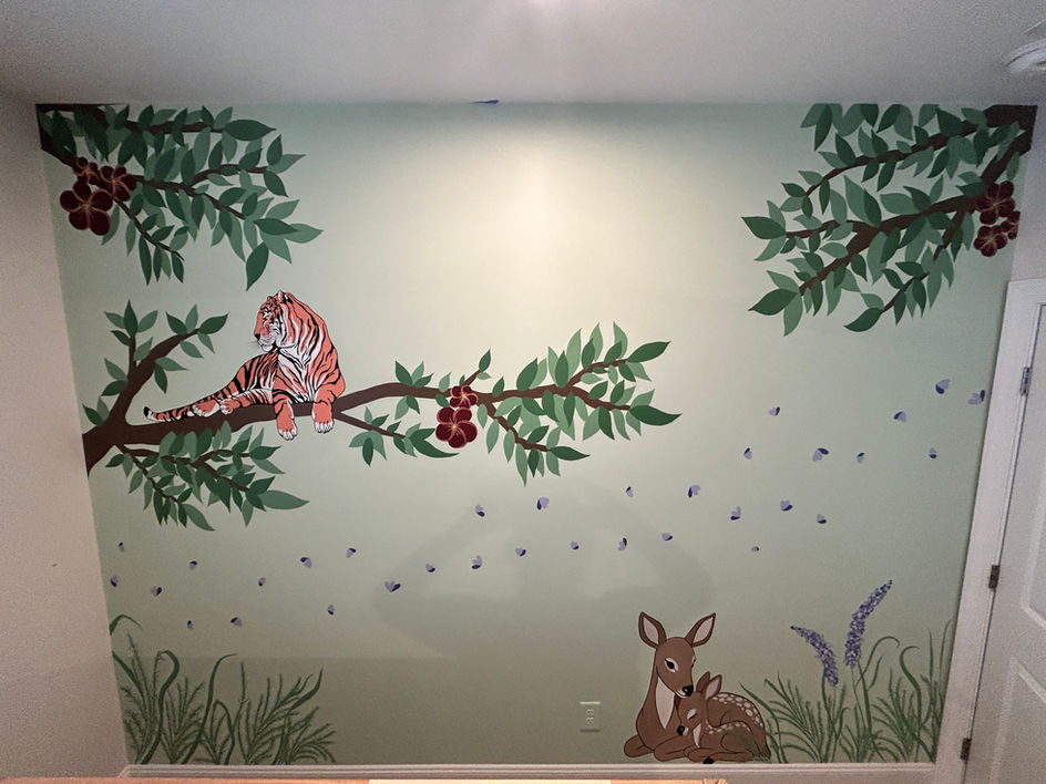 Hand-painted woodland mural with a tiger on a branch, leafy trees, flowers, and two fawns resting below.
