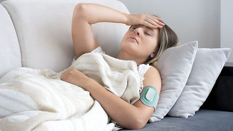 woman on sofa in pain using nerivio