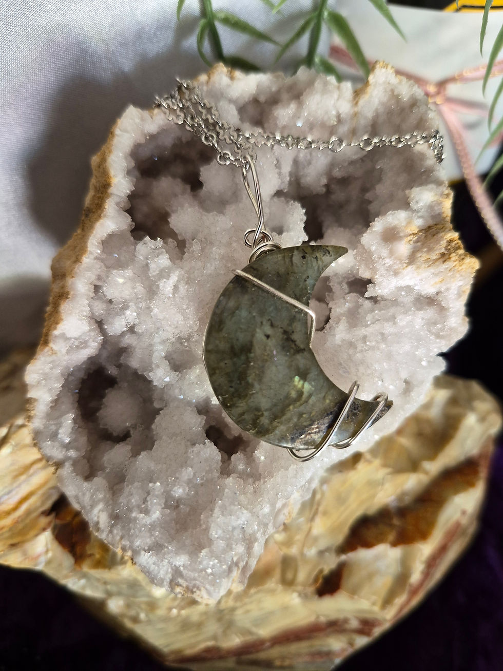 Moon shaped labradorite stone with a simple wire wrap to the top and 2 wrapped around the bottom. 1.5 in big