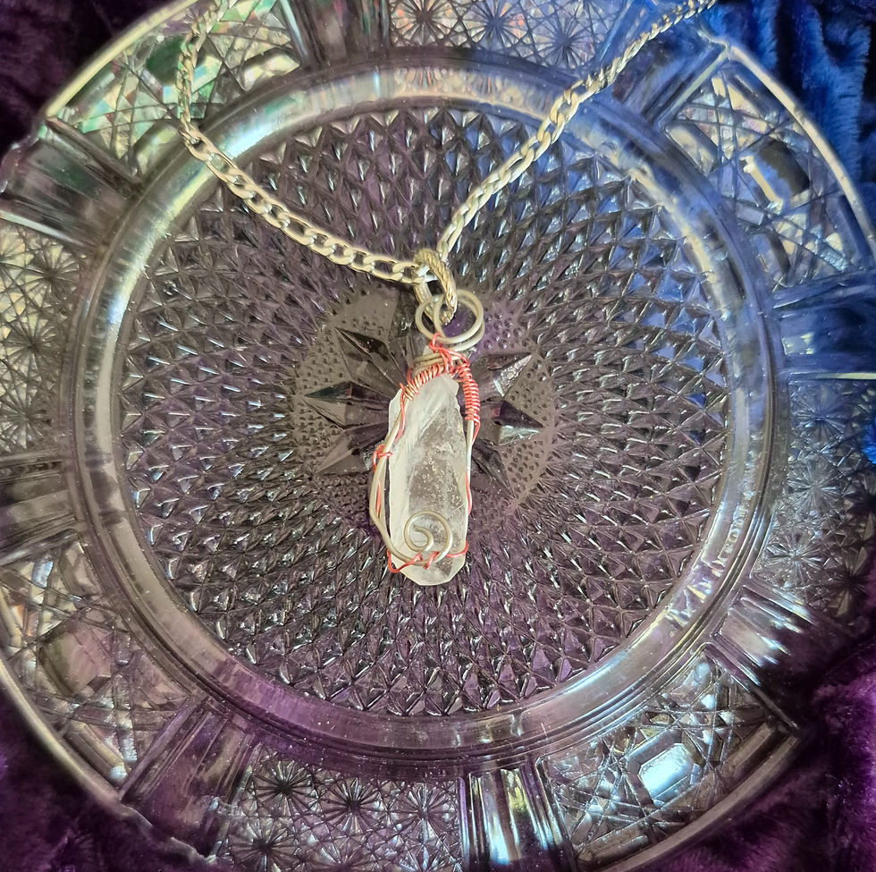 Clear quartz spike wrapped around the outside with pink wire for a pop of color on a stainless-steel chain