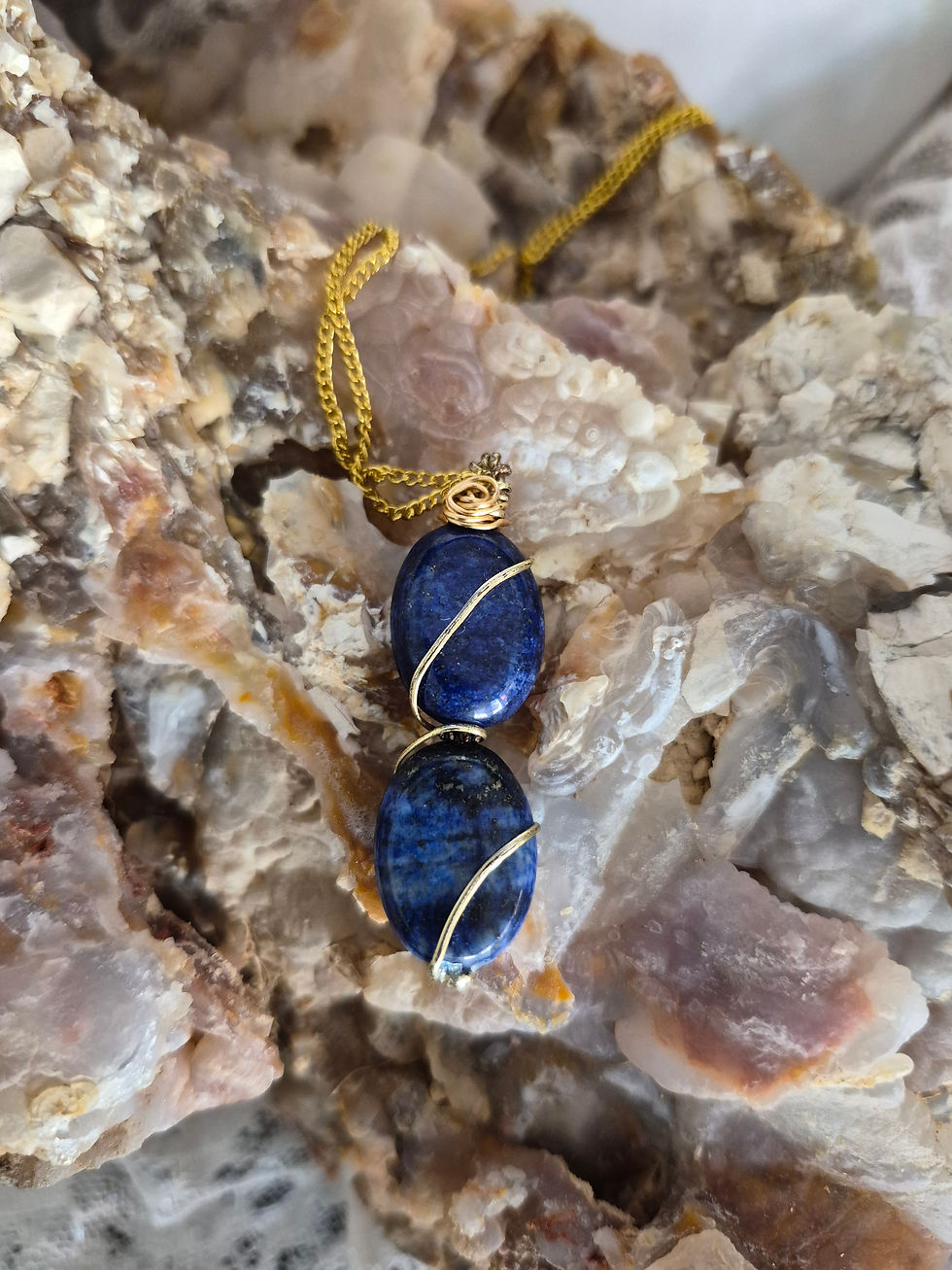 Two Lapis Luzuli stones- gold wire twists up both- stacked vertically