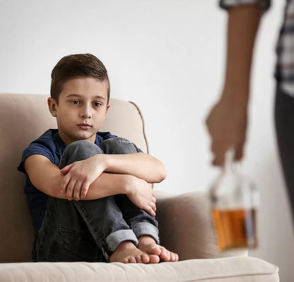 a child watching an adult with an alcohol bottle