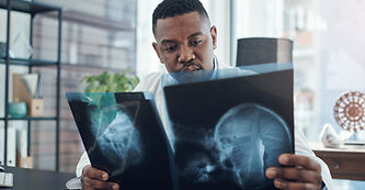 Healthcare, black man and surgeon with xray for diagnosis, check results or ideas in hospi