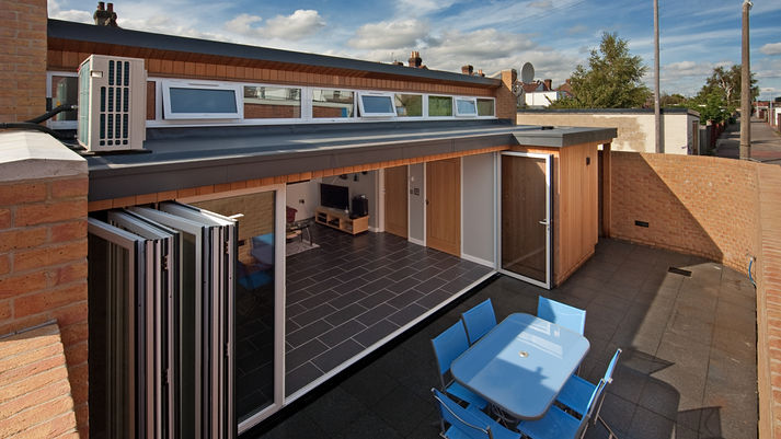 Architect designed dwelling with folding sliding doors opening onto a courtyard patio.