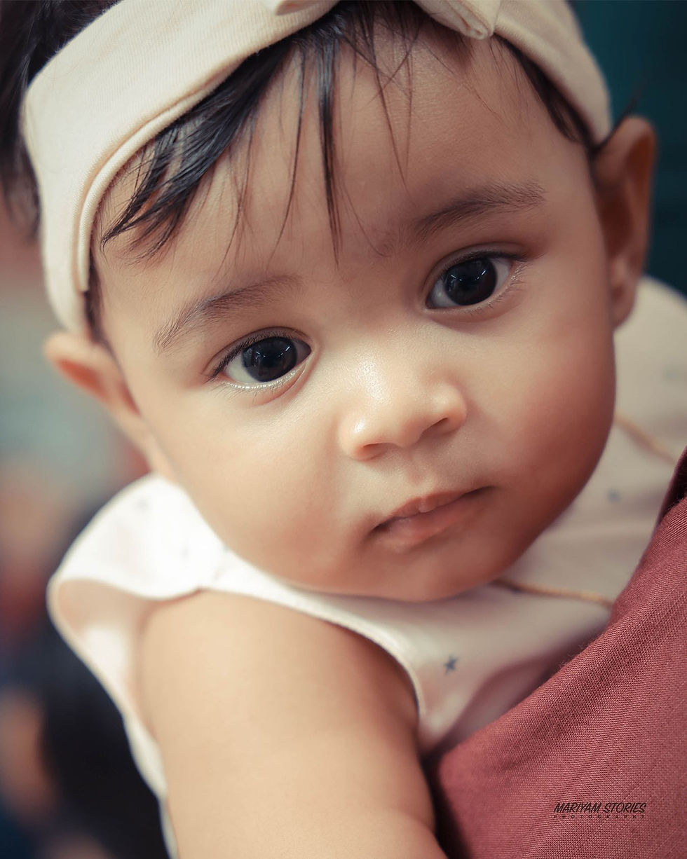 Eye-level view of a baby smiling during a photography session