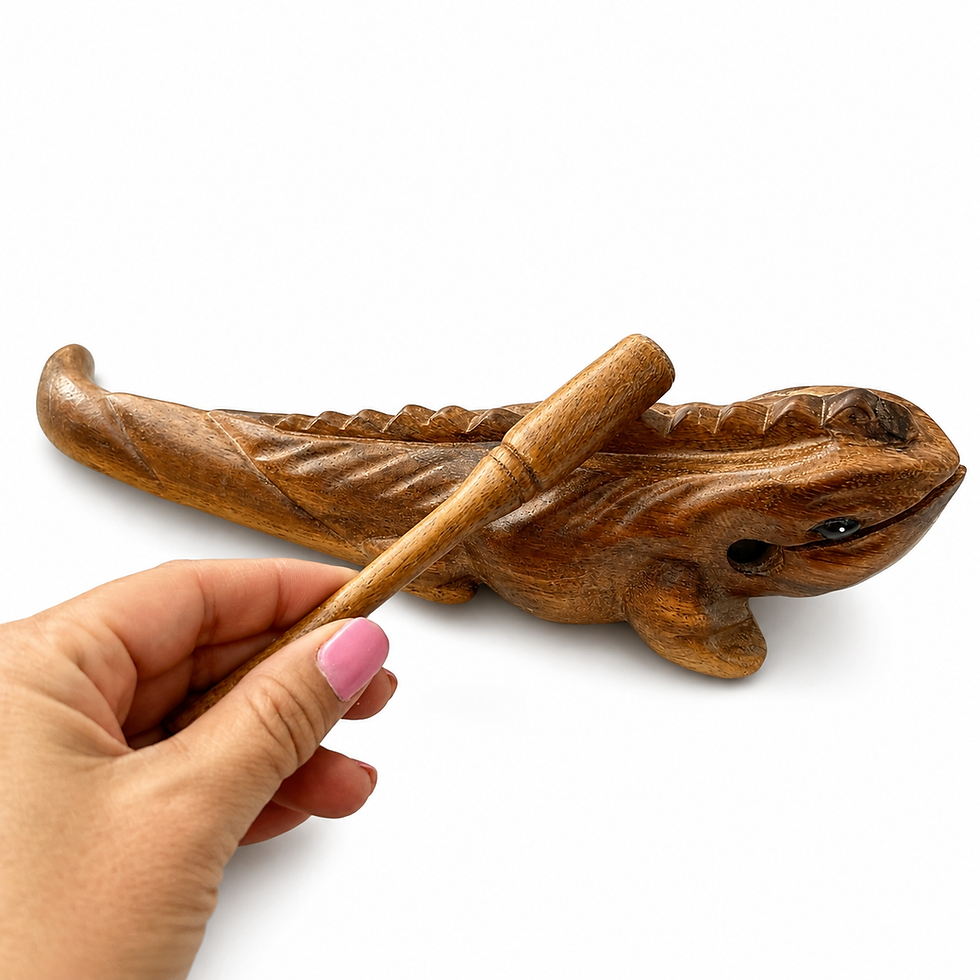 Thumbnail: Hand holding a wooden stick over a 12 inch wooden iguana.