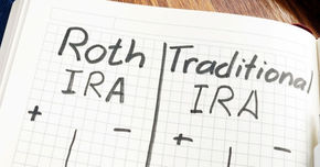 A handwritten comparison chart of Roth IRA vs. Traditional IRA on grid paper. The chart shows plus and minus signs under each column, suggesting pros and cons for both account types.