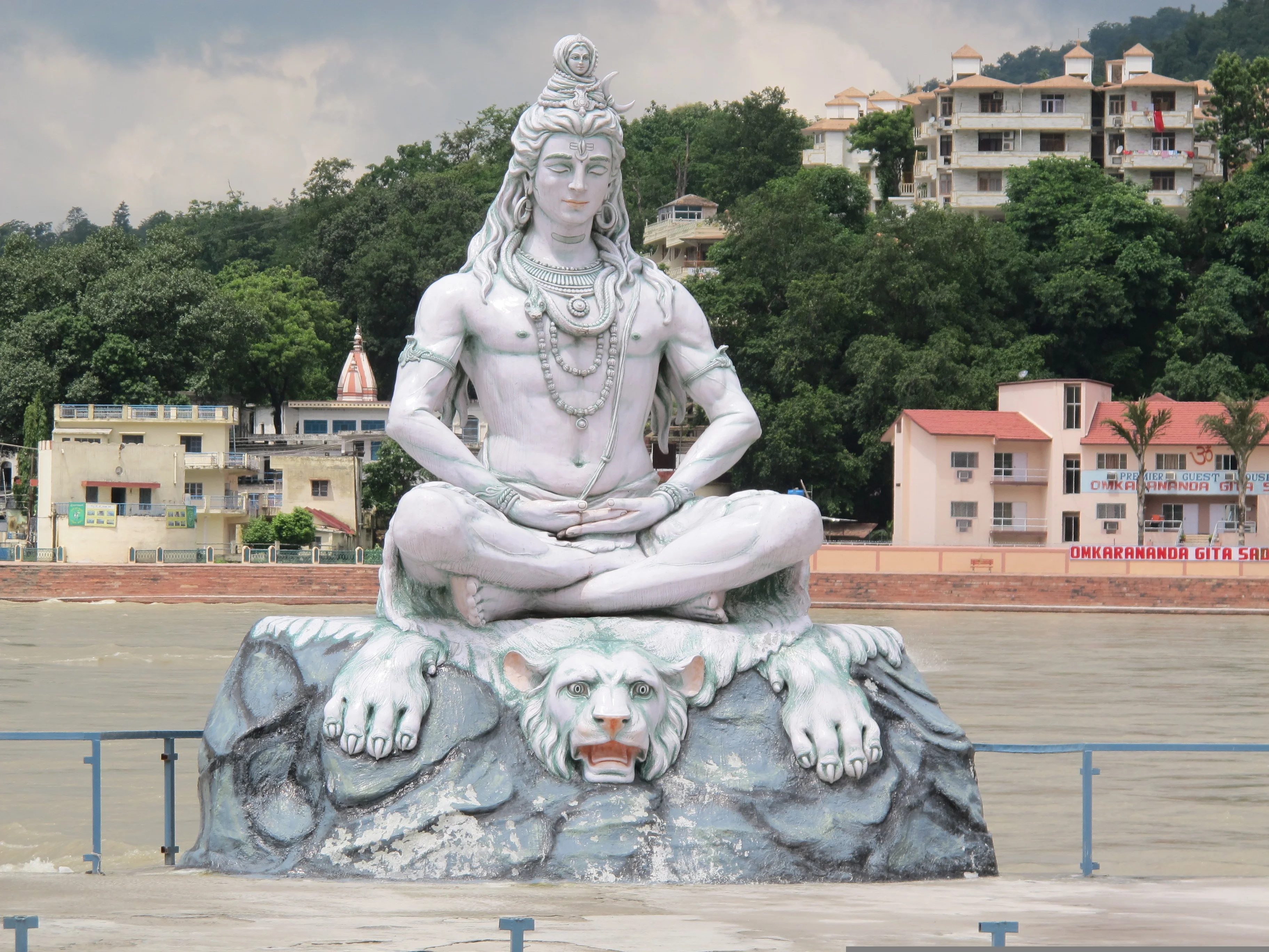 Lord shiva sitting in meditation over animal above the rock near bank of