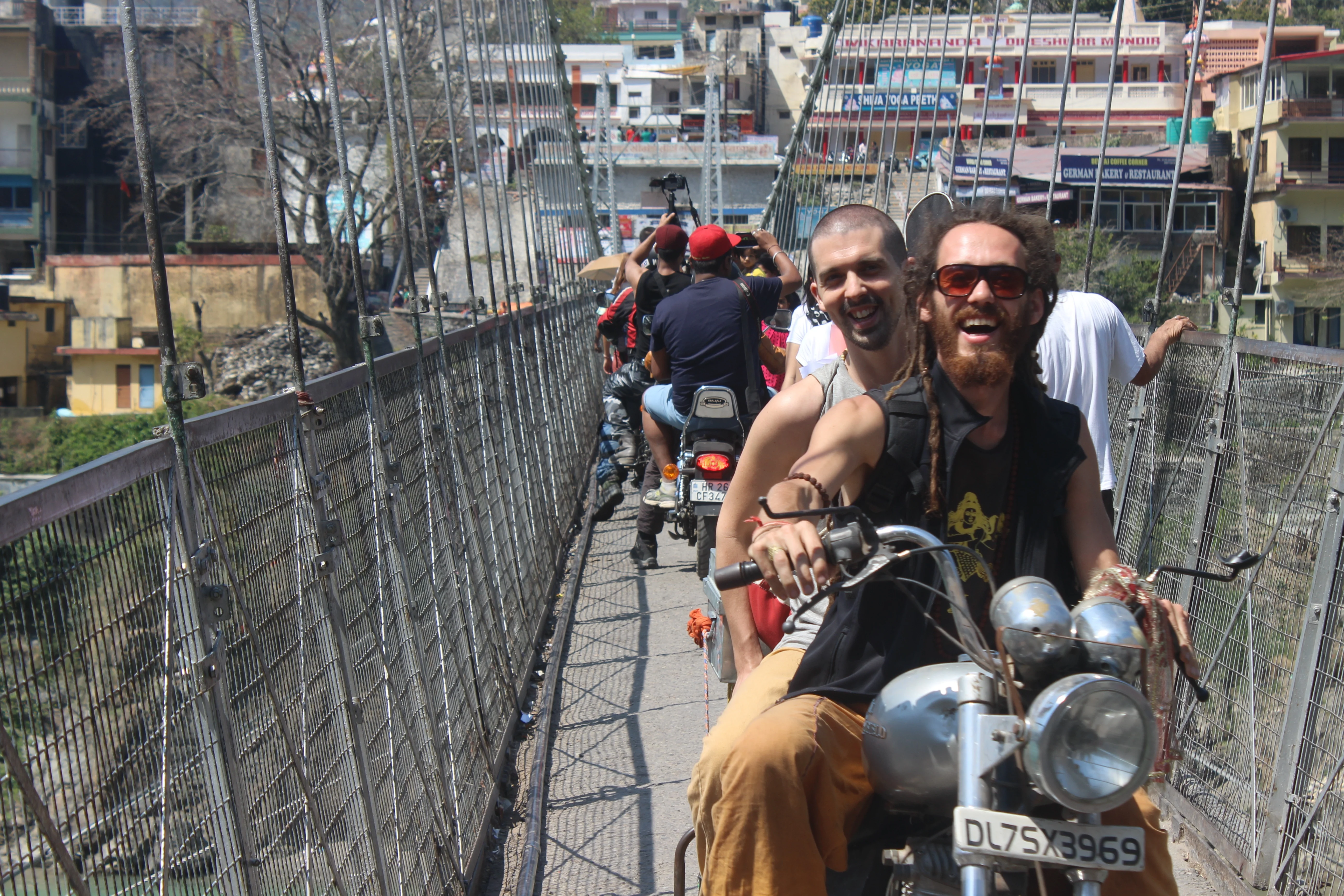 a suspension bridge with moving motorcycles