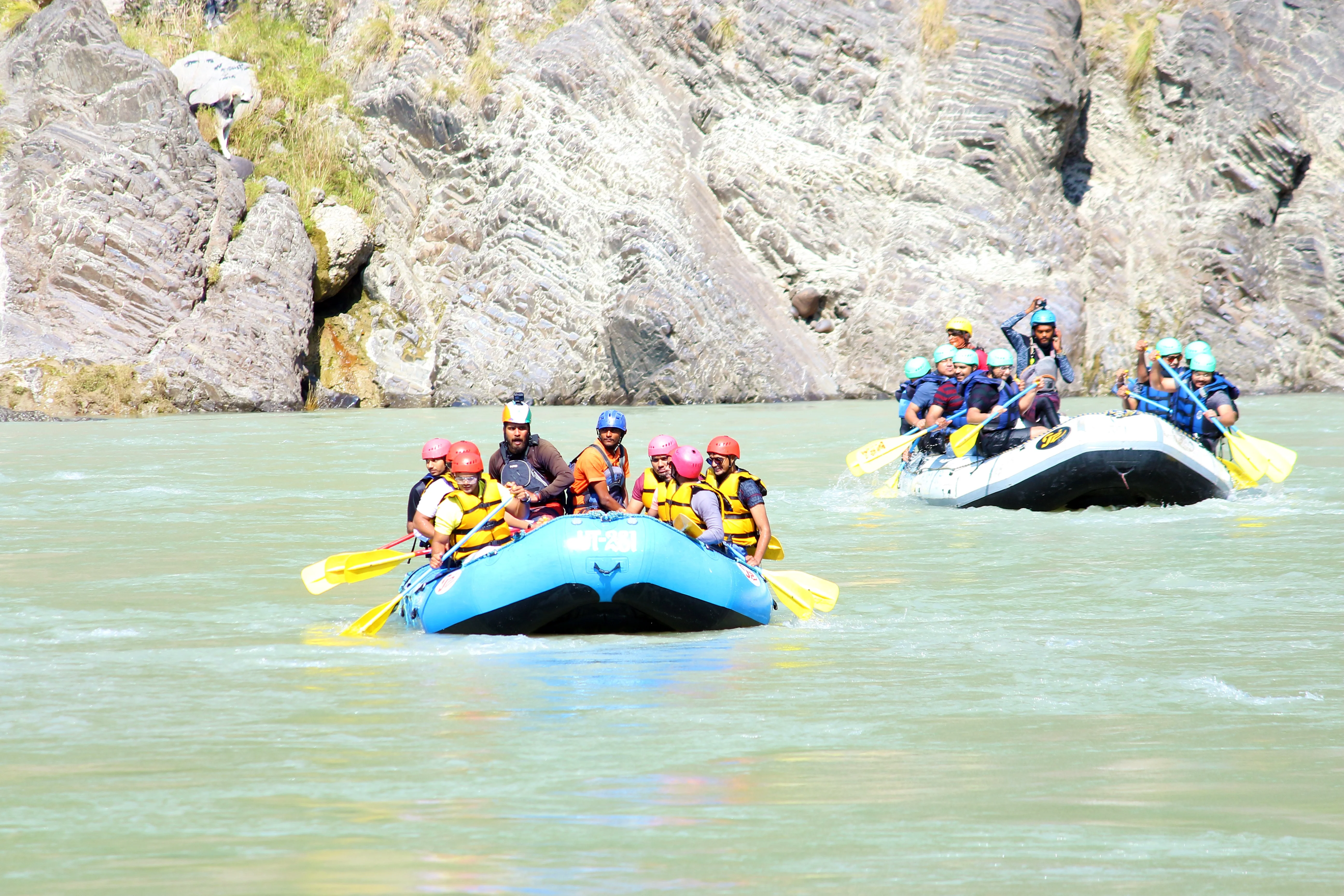 people doing water sport in boat carrying pedal in hand 