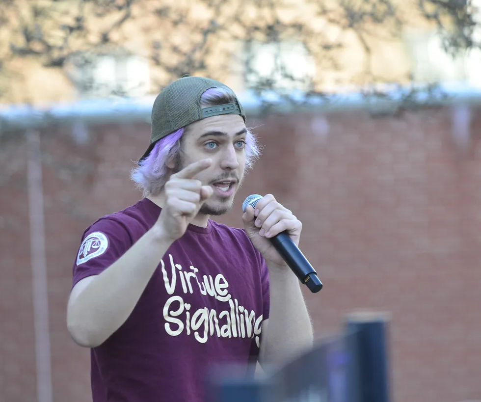 Reece Axel-Adams, a student and leader of the Student Solidarity Movement for the Union at Earlham, speaks at a protest in support of Earlham College's professors' efforts to unionize at the "Heart" of campus Wednesday afternoon, Feb. 21, 2024. | Pal-Item - Evan Weaver