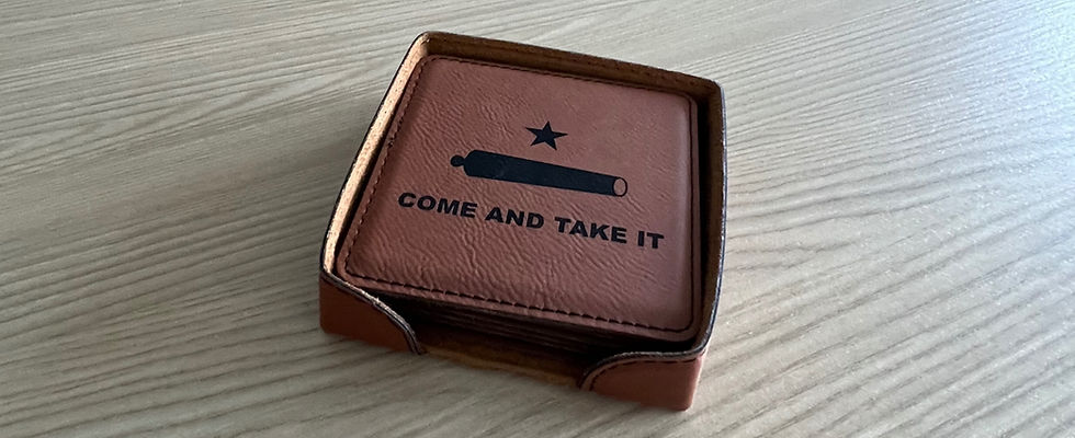 Stack of leather drinks coasters featuring a black Texas "Come and Take It" cannon and star design