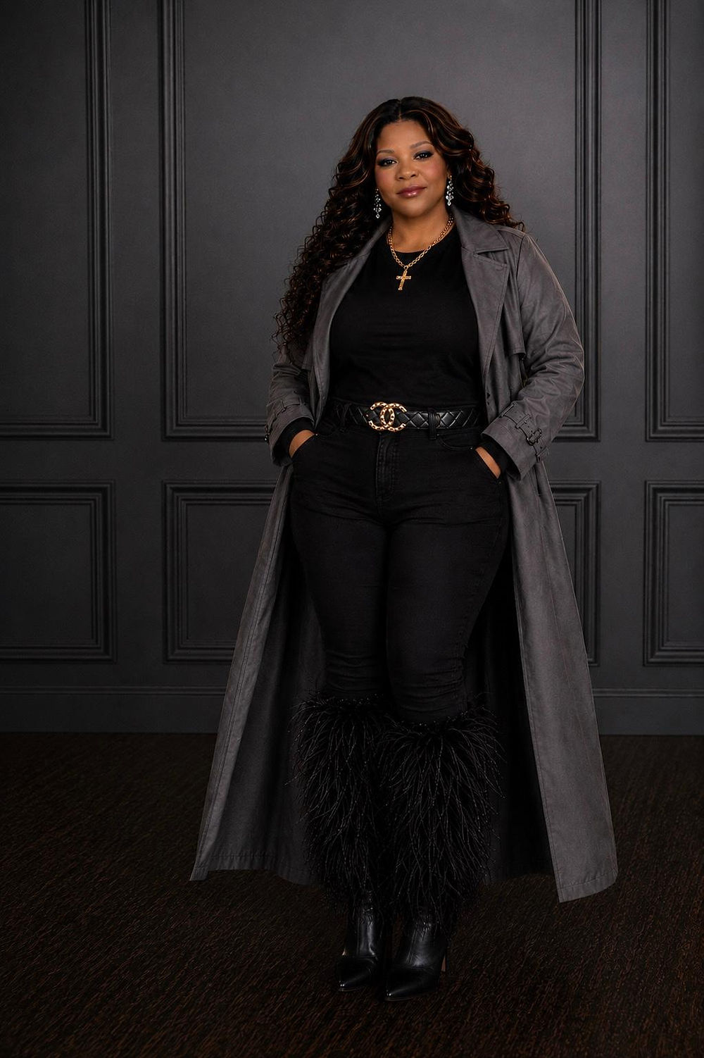 Dionne in a long grey coat and black outfit