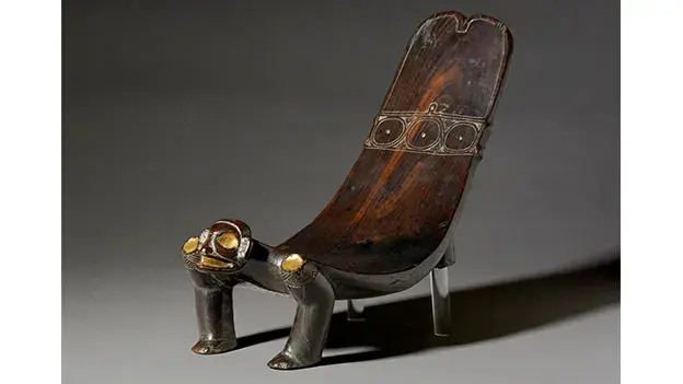 Ceremonial Taino Duho Chair: A carved wooden seat with intricate designs, used by a Arawak Taino Chief for important rituals and gatherings.