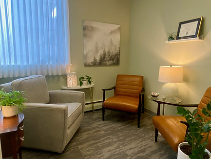 Melanie's office at The Counselling Collective. Soft lighting and plants provide a calming atmosphere.
