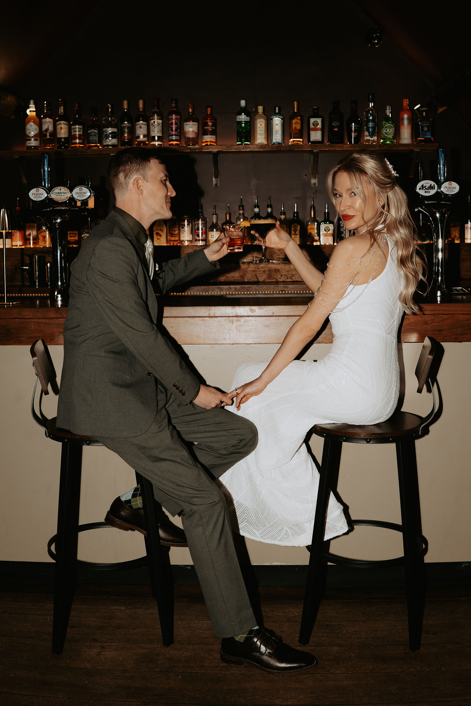 Bride and groom toasting drinks