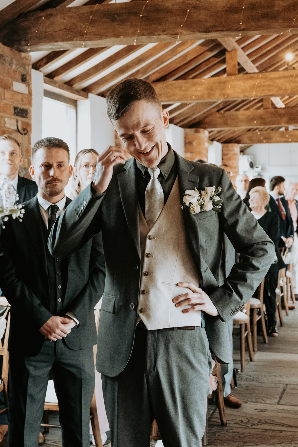 Groom crying at the top of the aisle