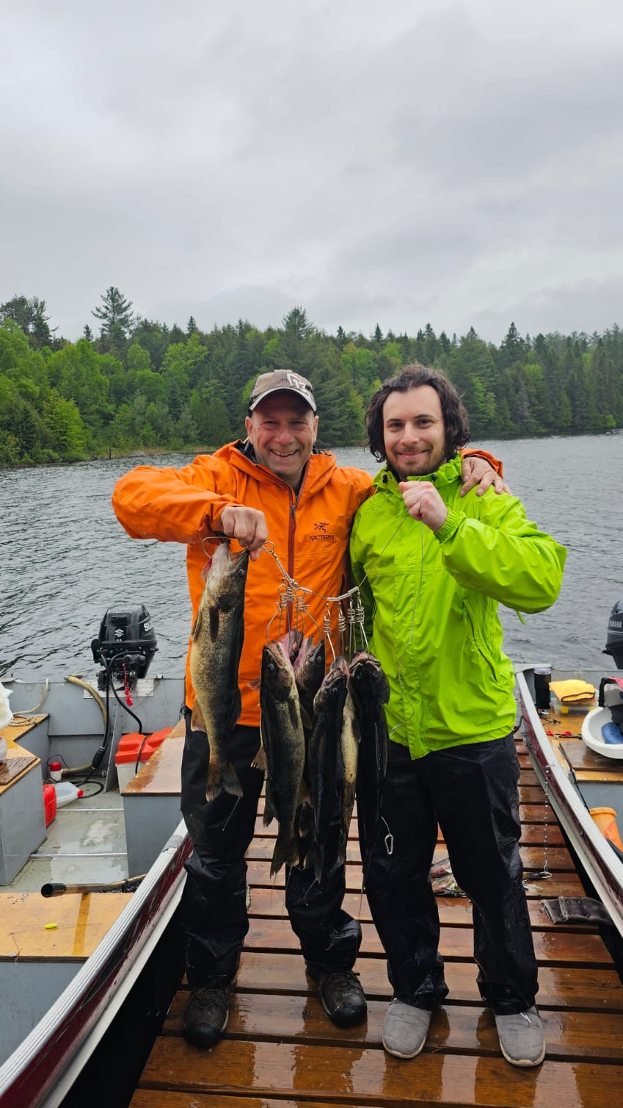 father and son holding fish