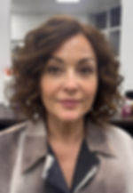 Loose wavy curly bob hairstyle for women over 50 with soft waves and natural body.