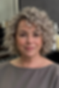 Soft curly bob with silver highlights for women over 50 adding volume and youthful movement.