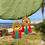 Thumbnail: Orecchini con ruote di carretto siciliano gialle e nappe colorate