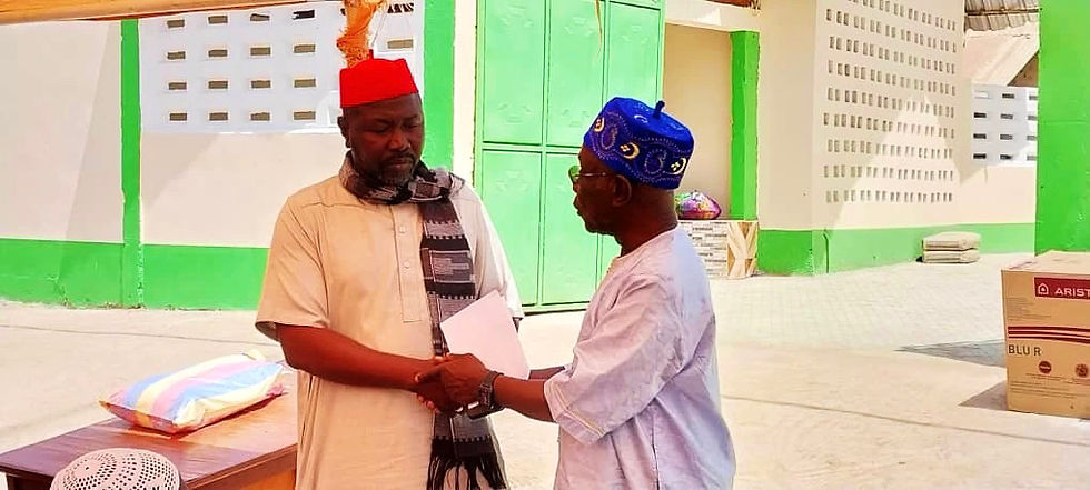 Dr Touray seen here presenting keys to the local mortuary of Gunjur to the Alikalo of Gunjur, Dembo Darboe