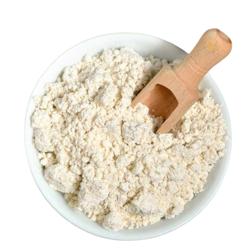 A white bowl full of a beige powder with a wooden spoon inside