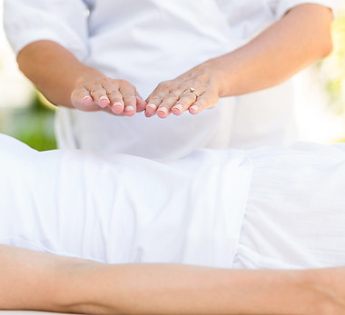 Calm woman receiving reiki treatment in the health spa.jpg