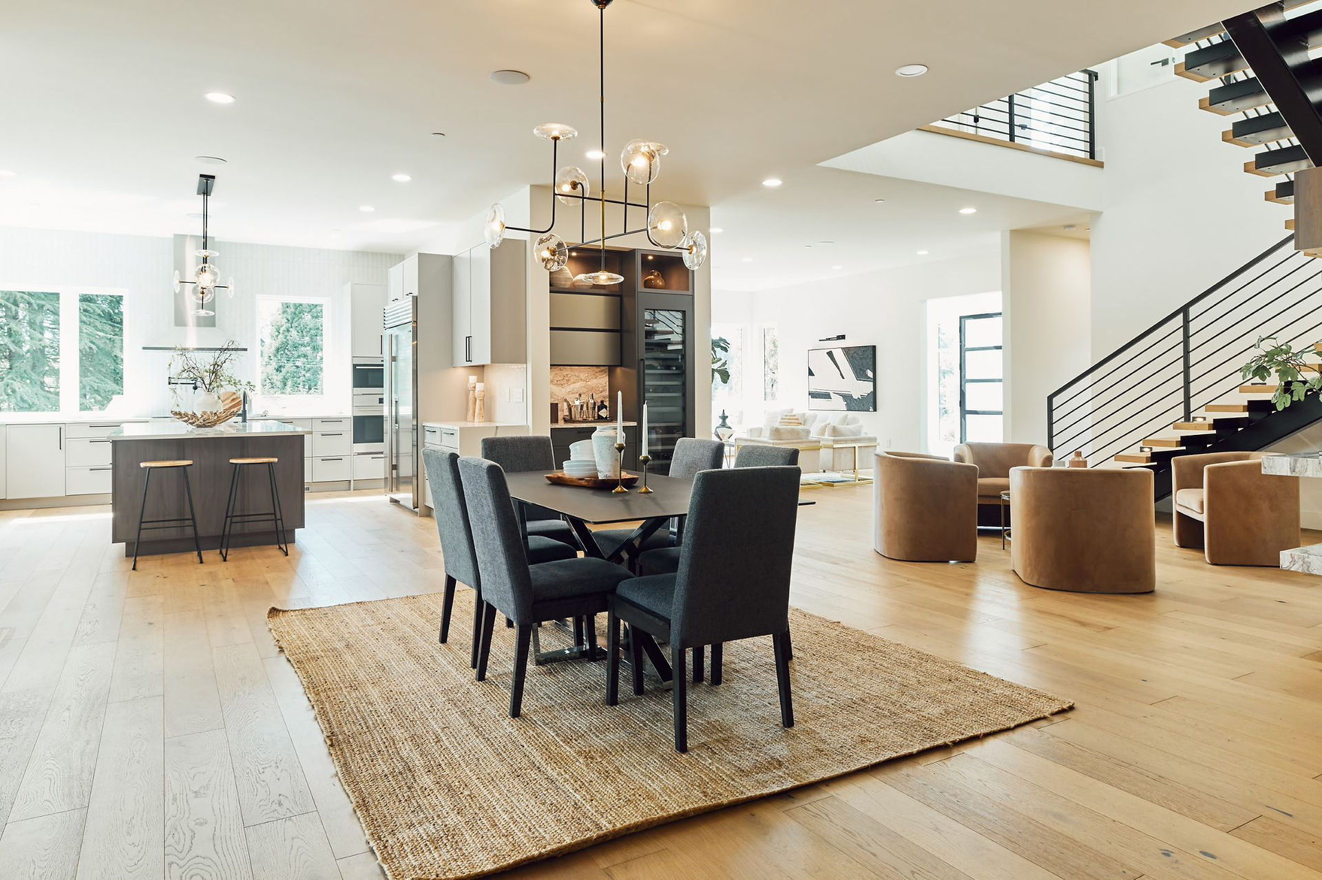 An open kitchen, dining, and living area in a modern custom home.