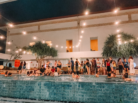Participants at Jean-Pictet socialising and relaxing at the pool-side after a long-day of simulations and work. (Alicia Rose)